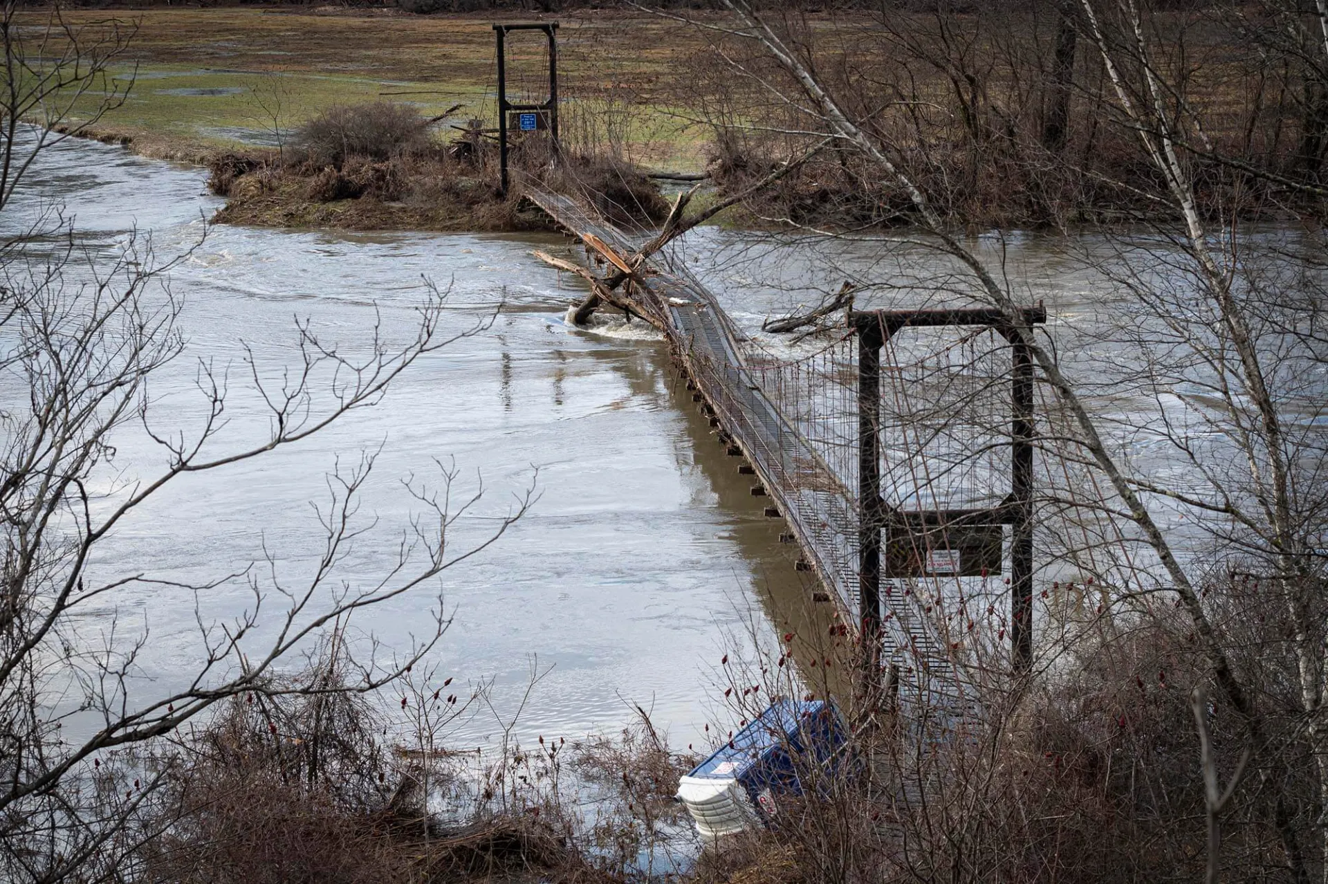 Debris is tangled in a snowmachine bridge across the Winooski River in Waterbury, VT in the wake of flooding on Tuesday, December 19, 2023