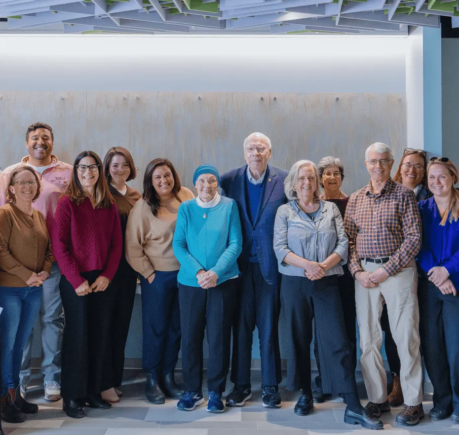 Marcelle and Patrick Leahy stand with UVM staff members.