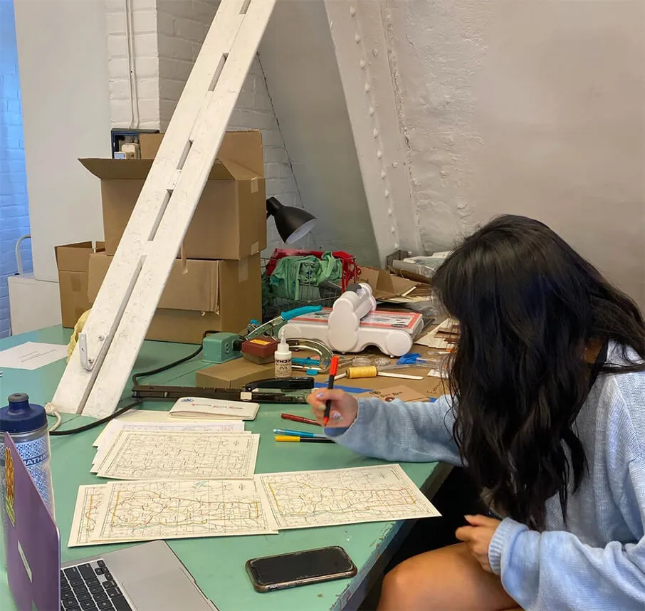 Person in lab working on map illustrations.