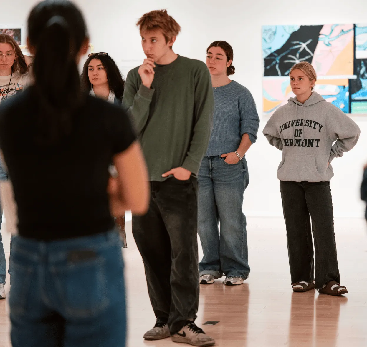 UVM students listening during a class visit to the museum.