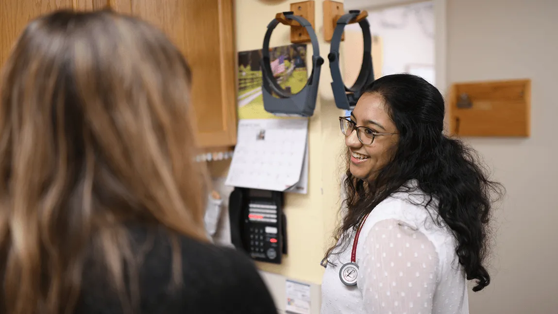 Medical student and doctor talking in doctor's office