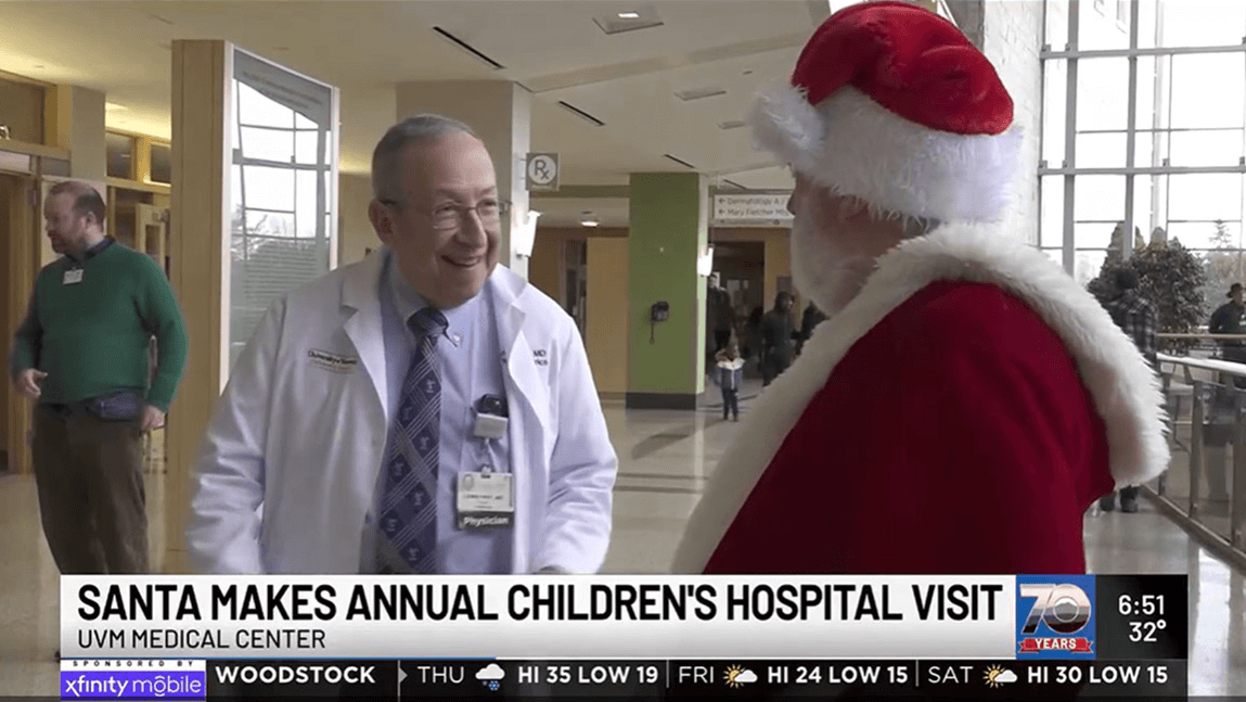 Dr. Lewis First with Santa Claus in the UVM Medical Center lobby