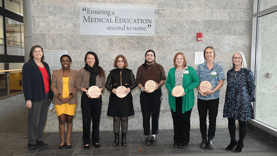 Group of people holding award plaques