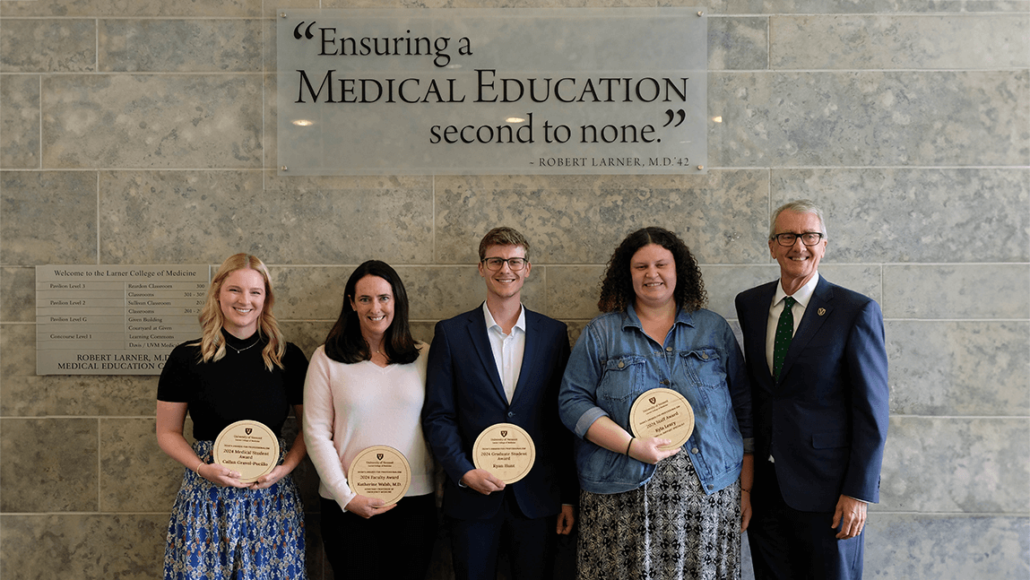 Group of people holding award plaques