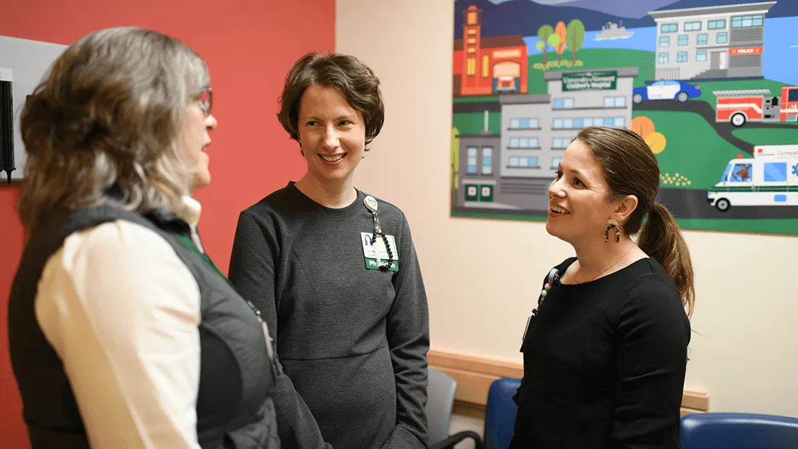 Three people talking in a doctor's office