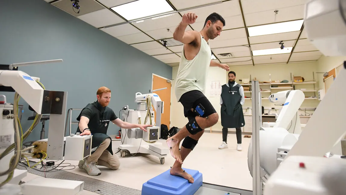 Person standing on one leg, getting knee tested for issues