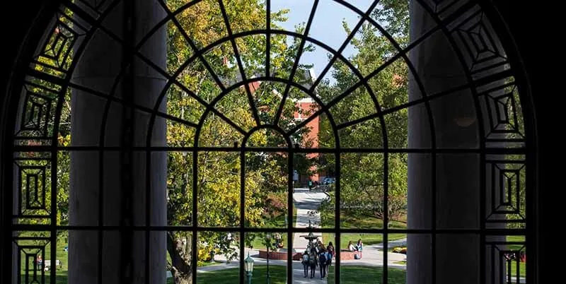 view of campus through arched window in Waterman Building