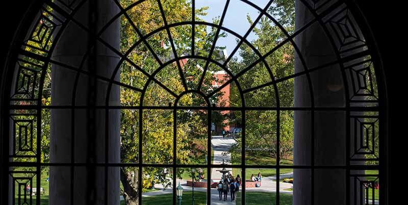 view of campus through arched window in Waterman Building