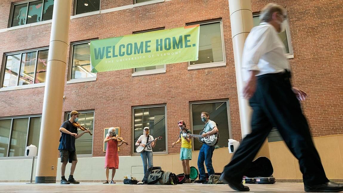 band playing music at the Davis Center on move in day with Welcome Home banner on the wall