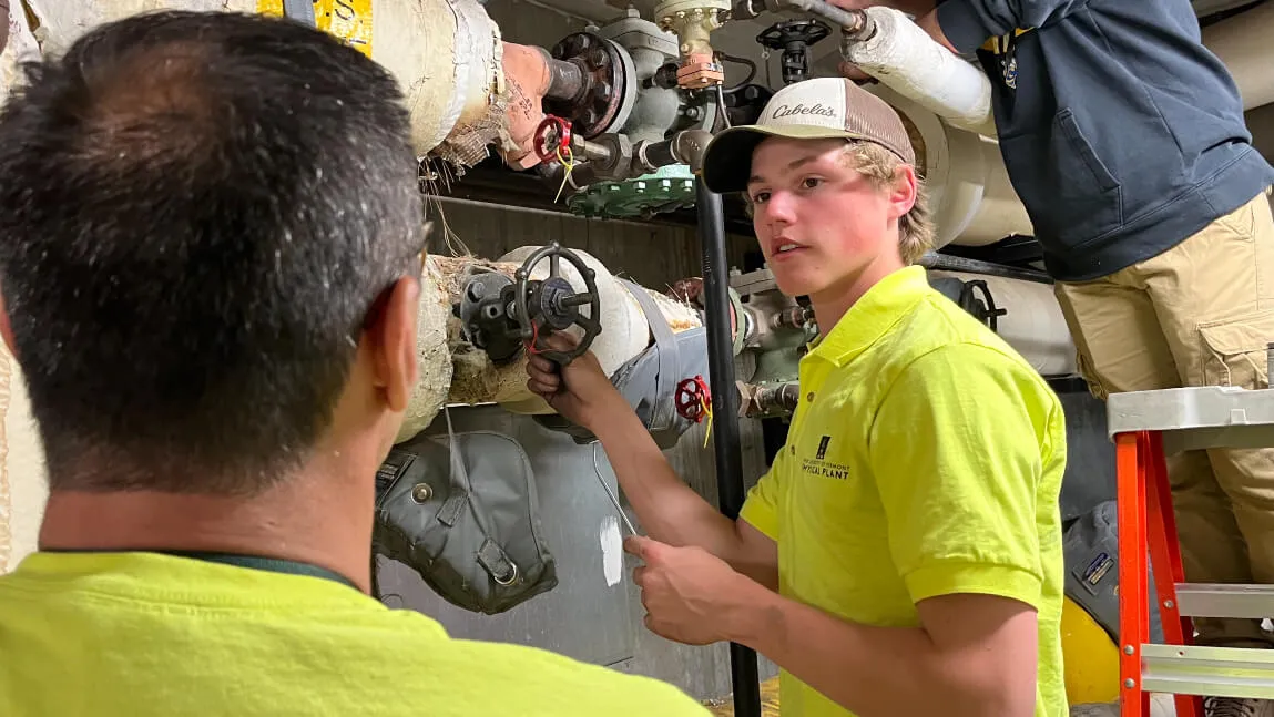 maintenance worker adjusting a valve