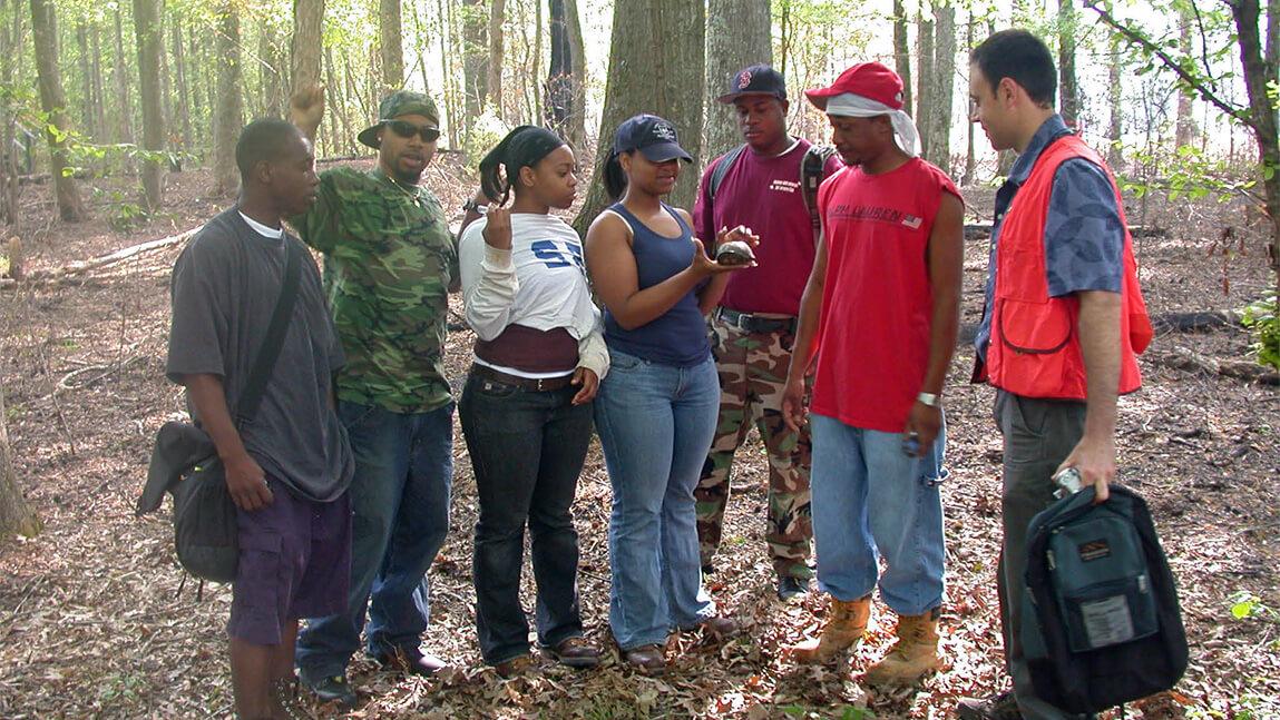 Group of Alabama Agricultural and Mechanical University students and instructor in the forest