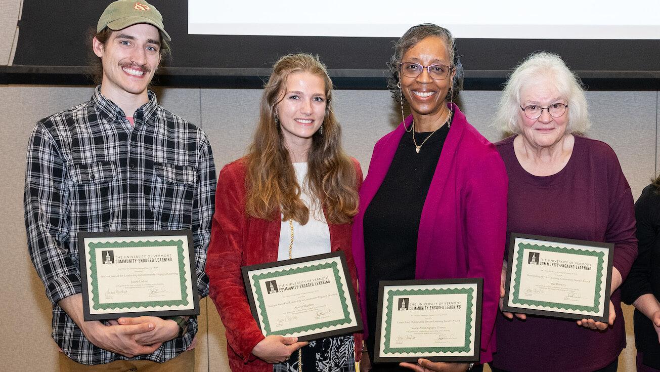 Row of 4 people (2 students, 1 faculty member, 1 staff member) holding their 2024 CELO awards