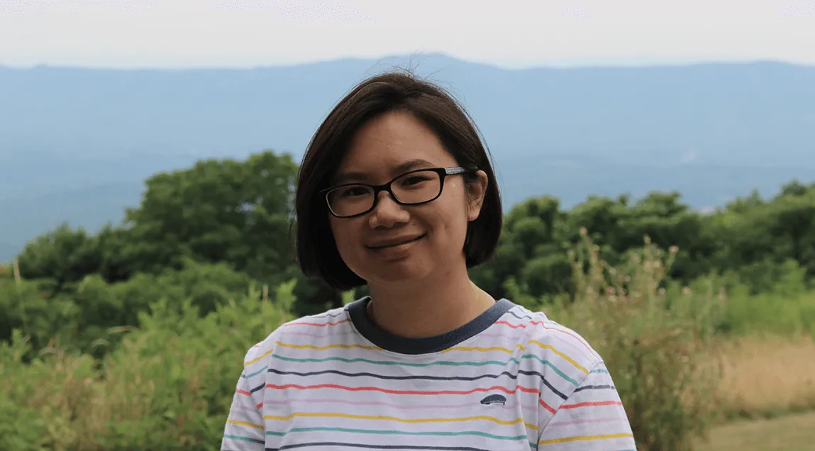 Jennifer Lai in foreground with forest and mountains in background