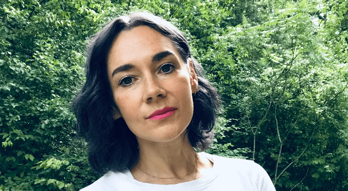 Meg Little Reilly surrounded by green leafy trees