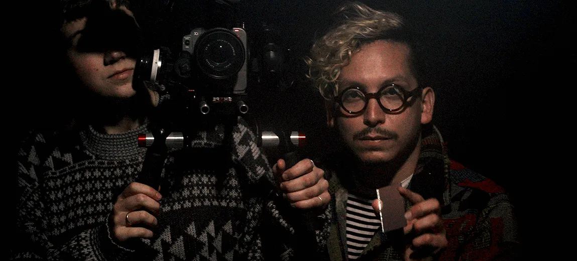 Milton behind the camera, shooting a scene in darkened conditions