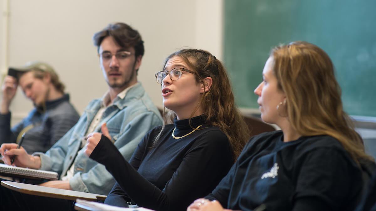 3 students participating in discussion in classroom