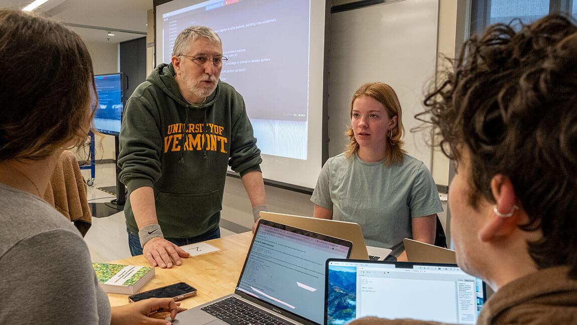 Senior Lecturer Clayton Cafiero assists students during a lab exercise