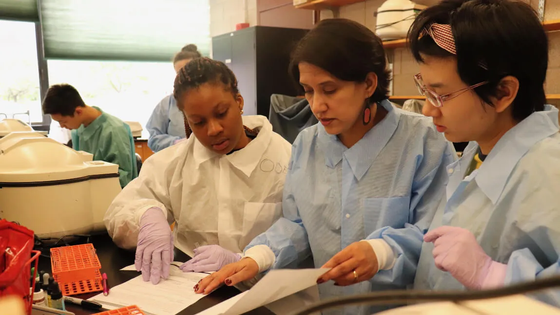 UVM faculty with students in lab