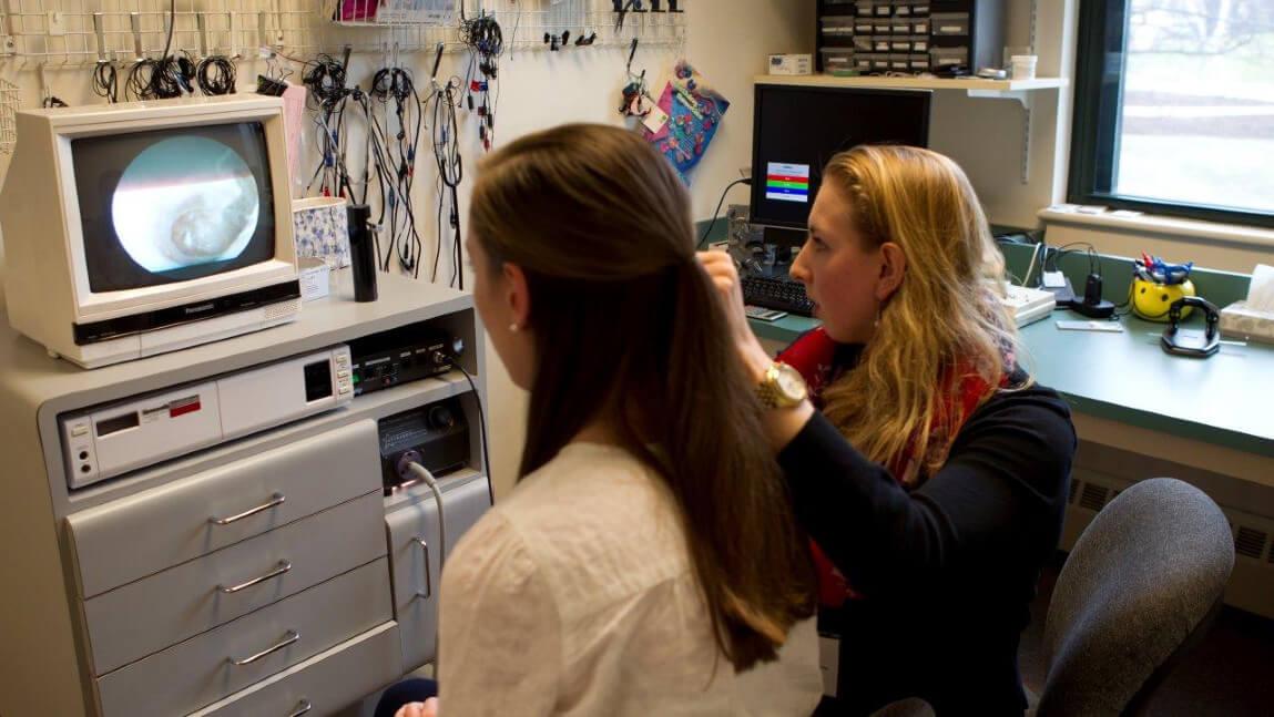 Clinician gives otoscope exam in UVM's Eleanor M. Luse Center