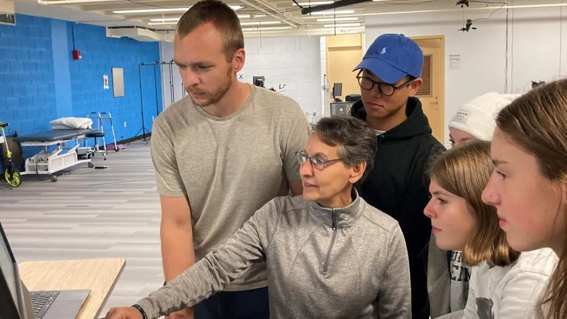 Professor Sue Kasser with students in lab
