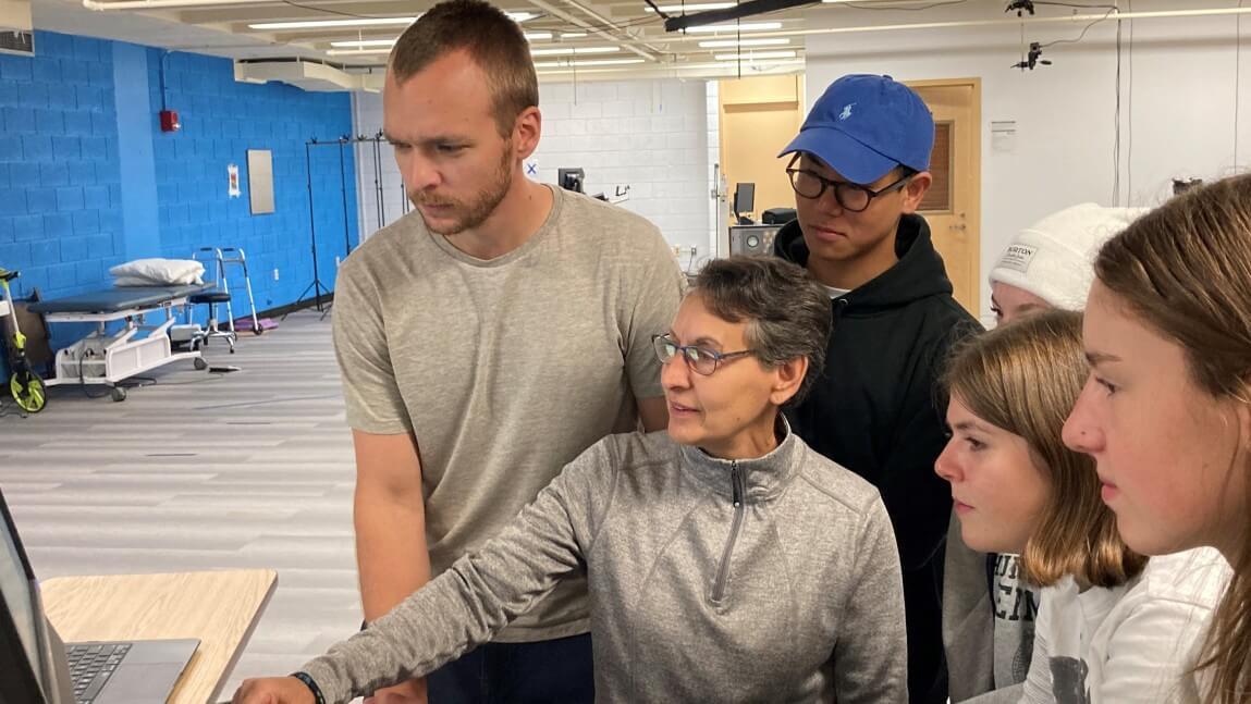 Professor Sue Kasser with students in lab