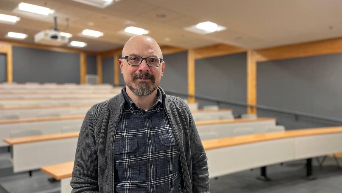 Ryan Kriger standing in front of a classroom.