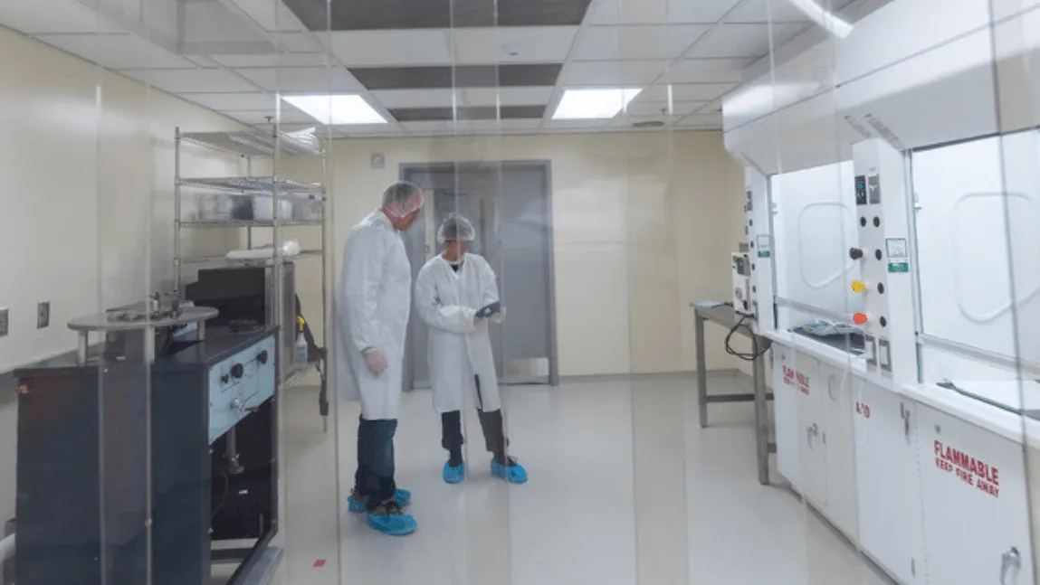 Two people standing in lab coats