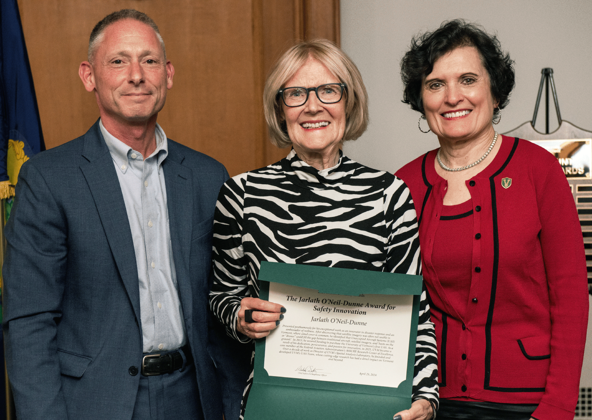 Mairi O'Neil Dunne accepts a safety award, presented by Michael Schirling and Patricia Prelock