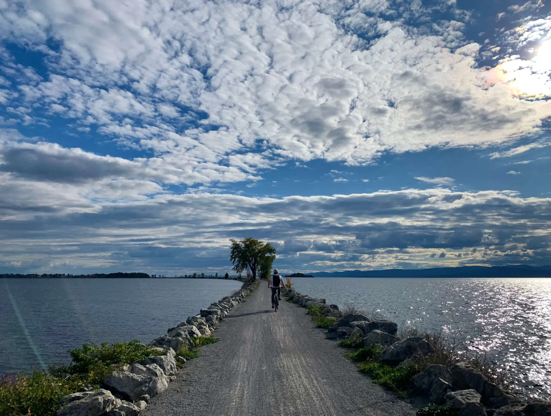 A view of the Colchester causeway, a bright blue sky and white fluffy clouds overhead.