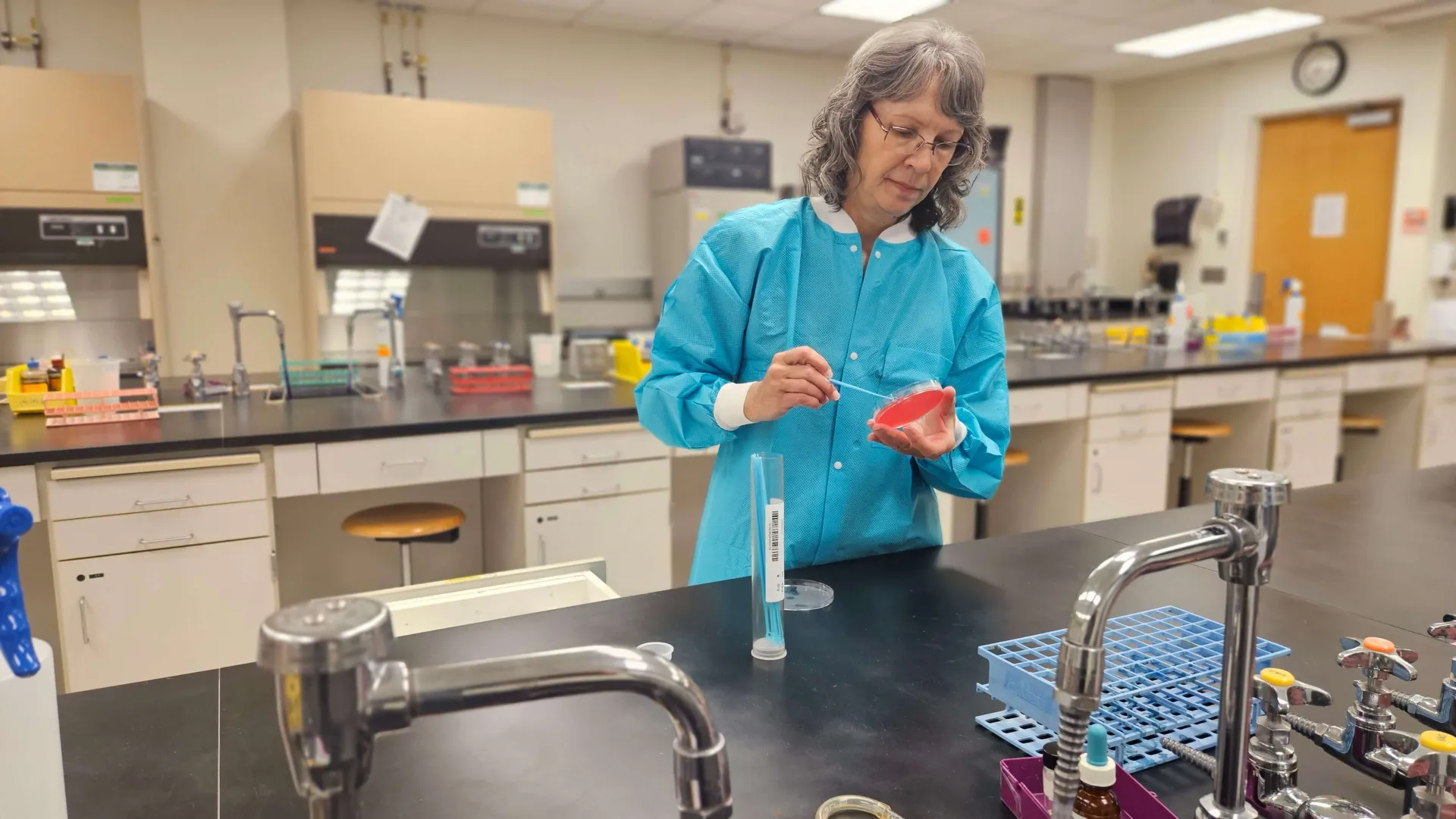 Lynn Willette, Research Assistant, prepares cultures in the lab.