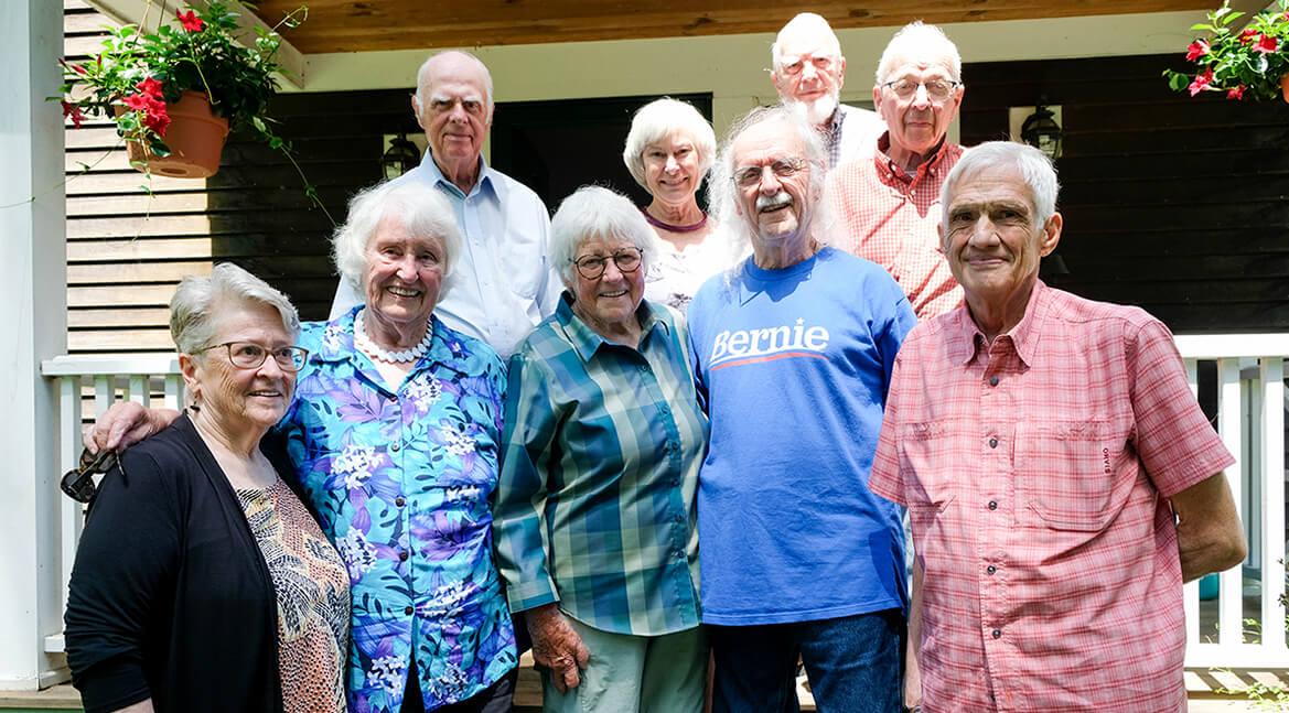 a group of people from the medical class of 1967 standing on porch steps
