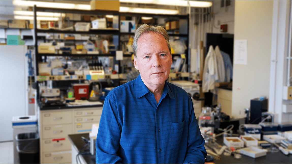 a man standing in an academic lab