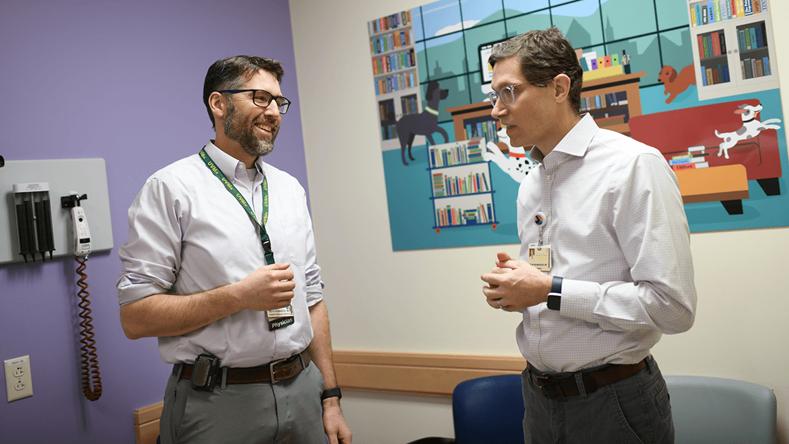 two people talking in a pediatriac waiting room