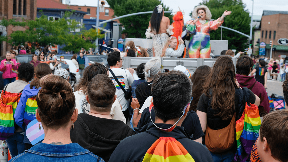 Pride flags, people marching and drag queens at Burlington's Pride Parade