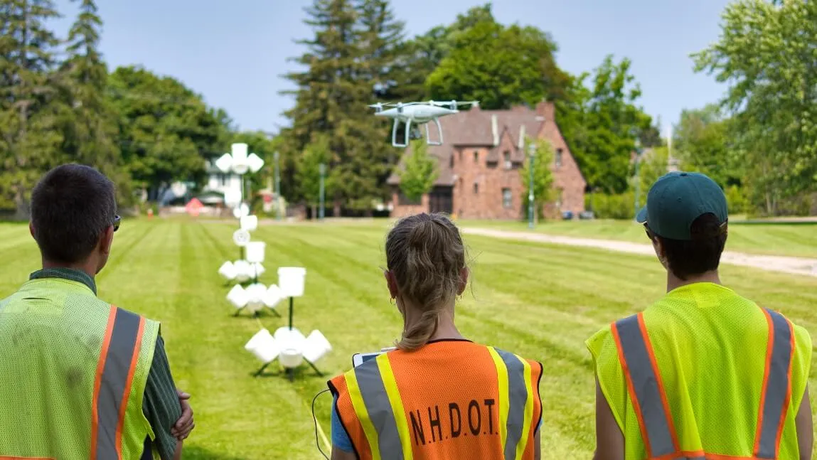 Three people flying a drone