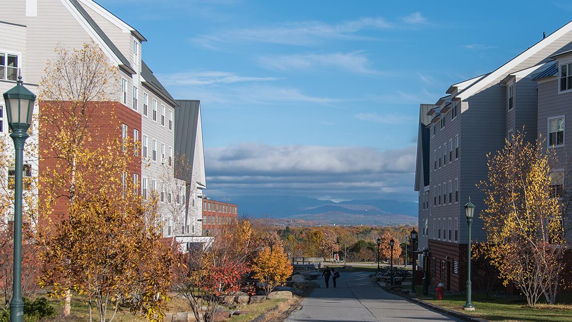 students walking at university heights with mountains in distance
