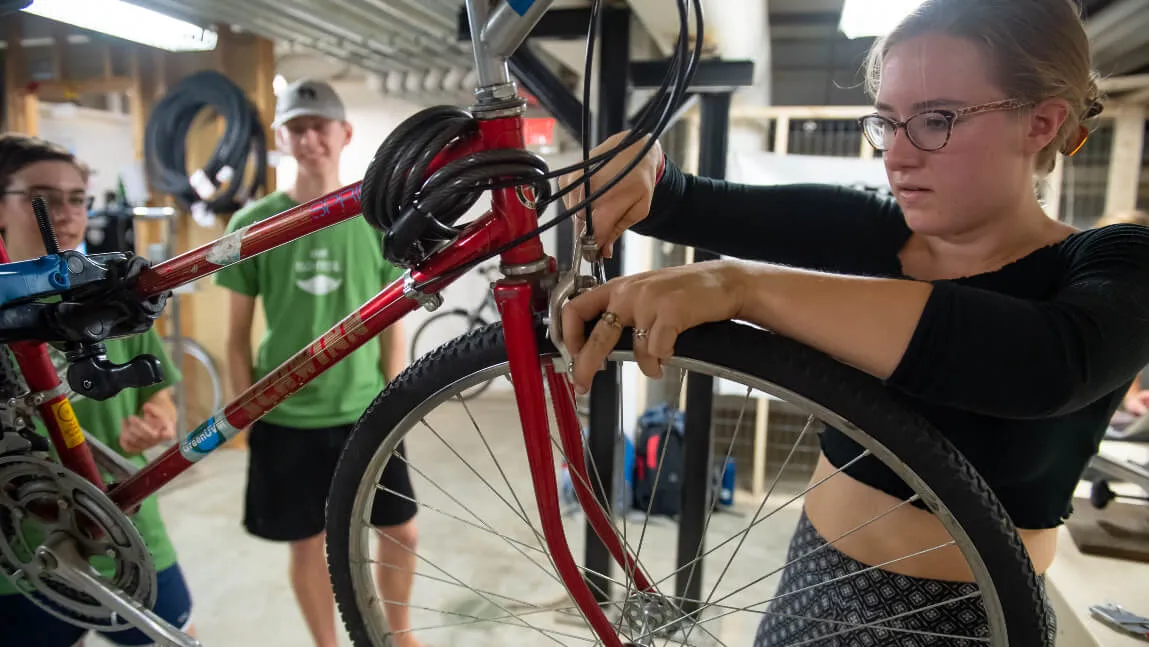 woman repairing a bike