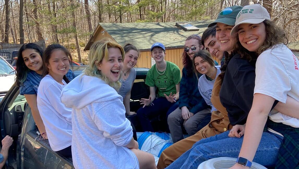 Students in the back of a truck at a sugaring operation.