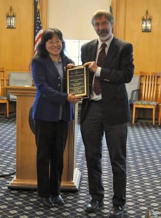 Dr. Liang receives the Hubert Vogelmann award from the Dean of the College of Agriculture and Life Sciences, Thomas Vogelmann.