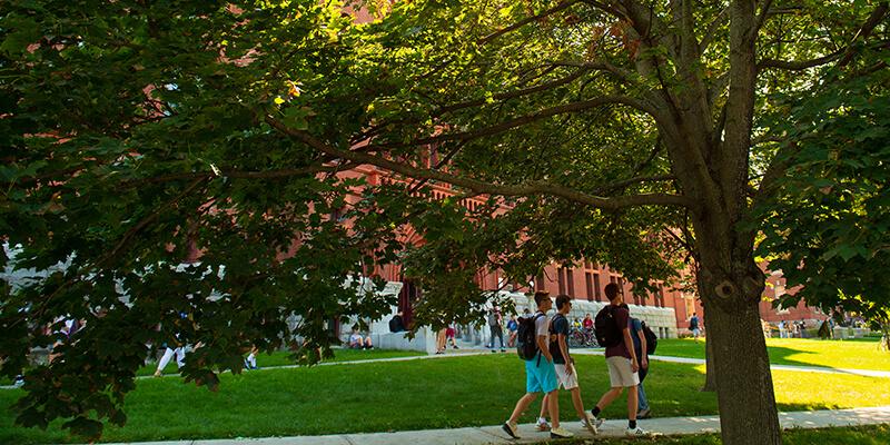 students walking on campus without masks