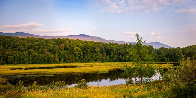 Vermont spring scene mountains field and stream 
