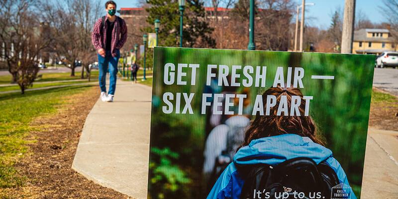 get fresh air six feet apart sign on campus