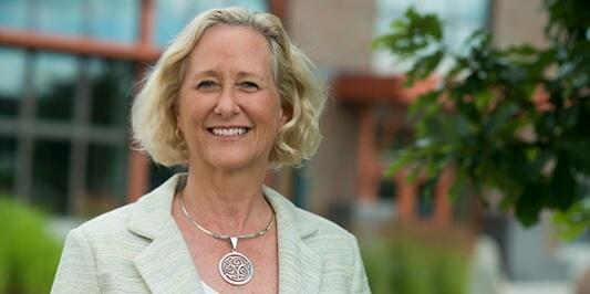 Dean Nancy Mathews in front of Aiken