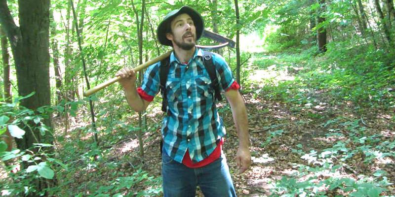 Summer UVM Natural Areas field intern Adam Heckle busy scouting out the route of the new trail system at the Carse Wetland Natural Area in Hinesburg, VT. Photo by Rick Paradis.