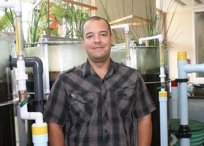 Anthony McInnis, Rubenstein School assistant professor in ecological design next to the Aiken Eco-Machine