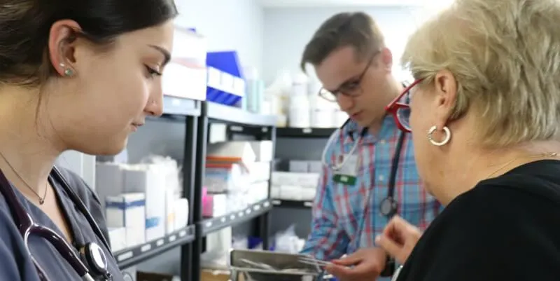 Nursing student and nurses look for supplies.