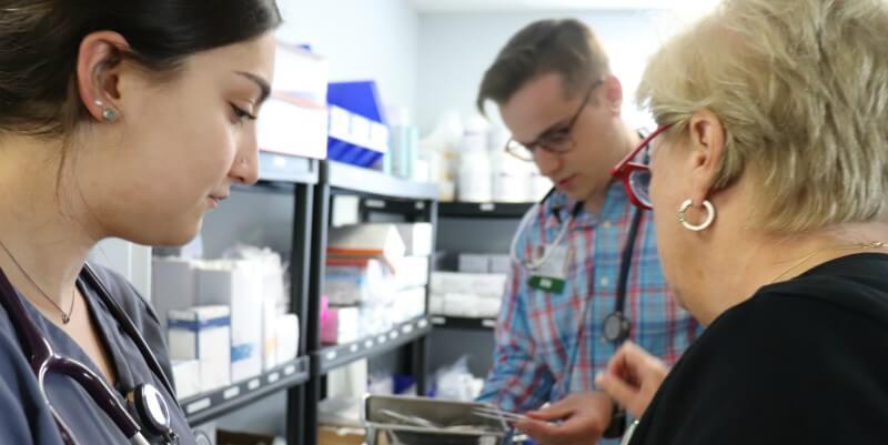 Nursing student and nurses look for supplies.