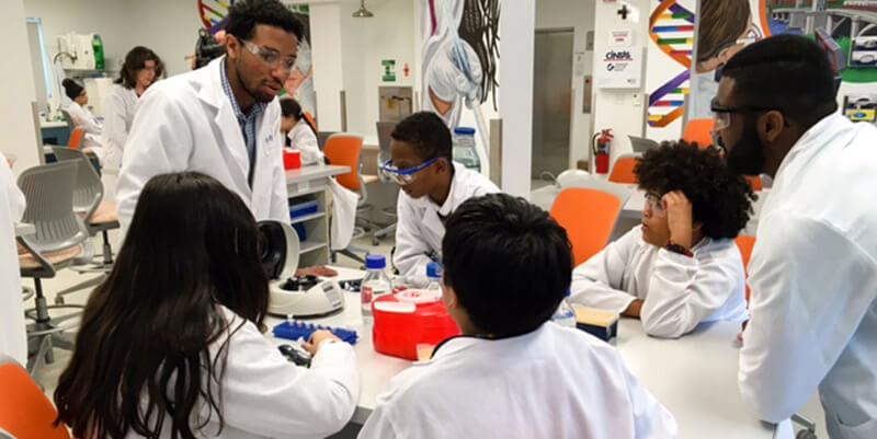 volunteers with kids in a lab. 