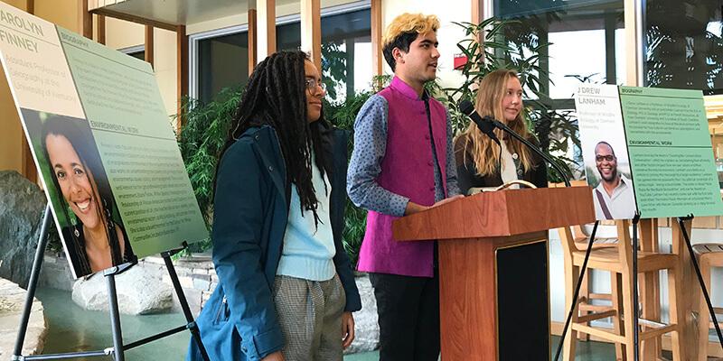 Students Cat Lawrence, Kunal Palawat, and Kirsti Carr at podium