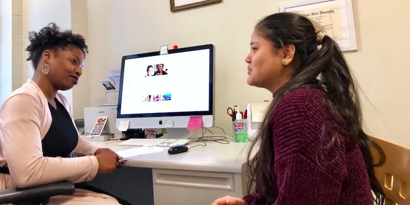 Briana Martin helping a student in her office at UVM.